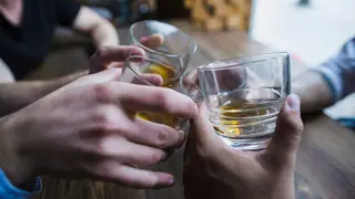 close-up-hands-toasting-whisky-glasses (1)