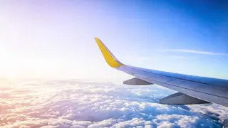 View of the clouds and sunset from an airplane window