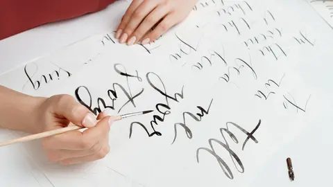 Girl writing calligraphy on postcards. Art design. Copy space.