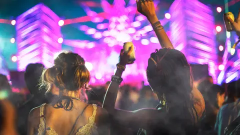 People at concert with smoke overlay texture